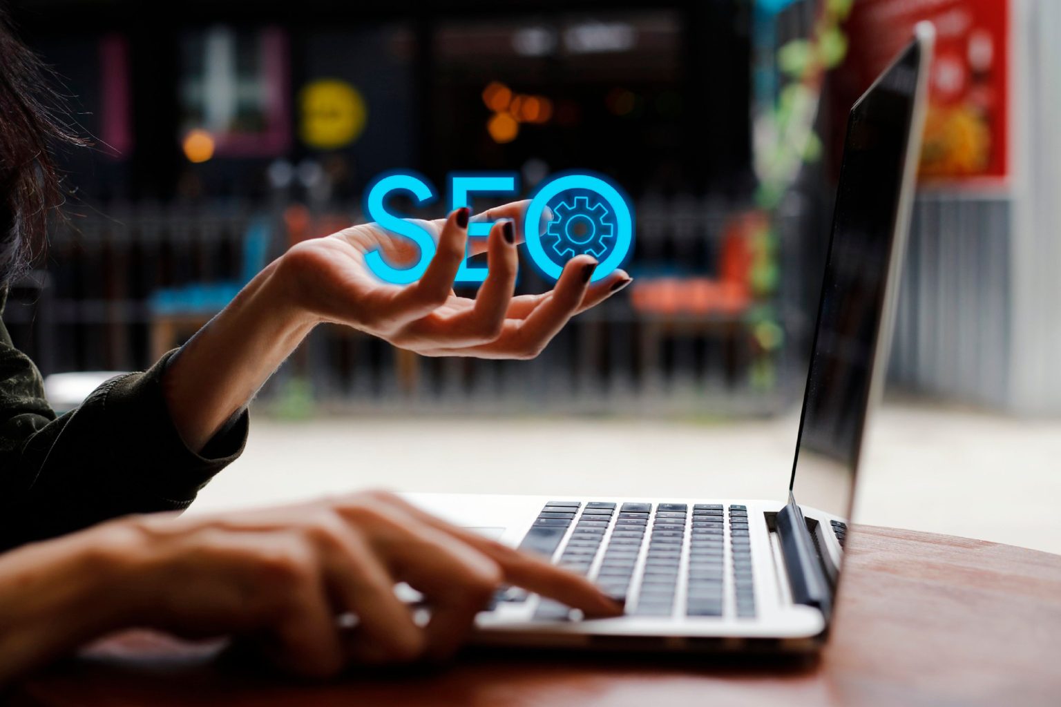 A woman using a laptop to consider SEO ranking factors when redesigning a website.