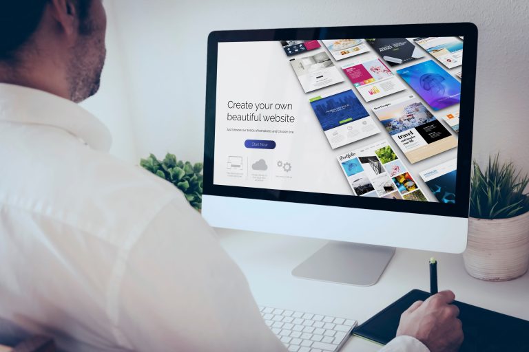 A man at a desk, using a top website builder to create his small business&#039;s comprehensive online presence.