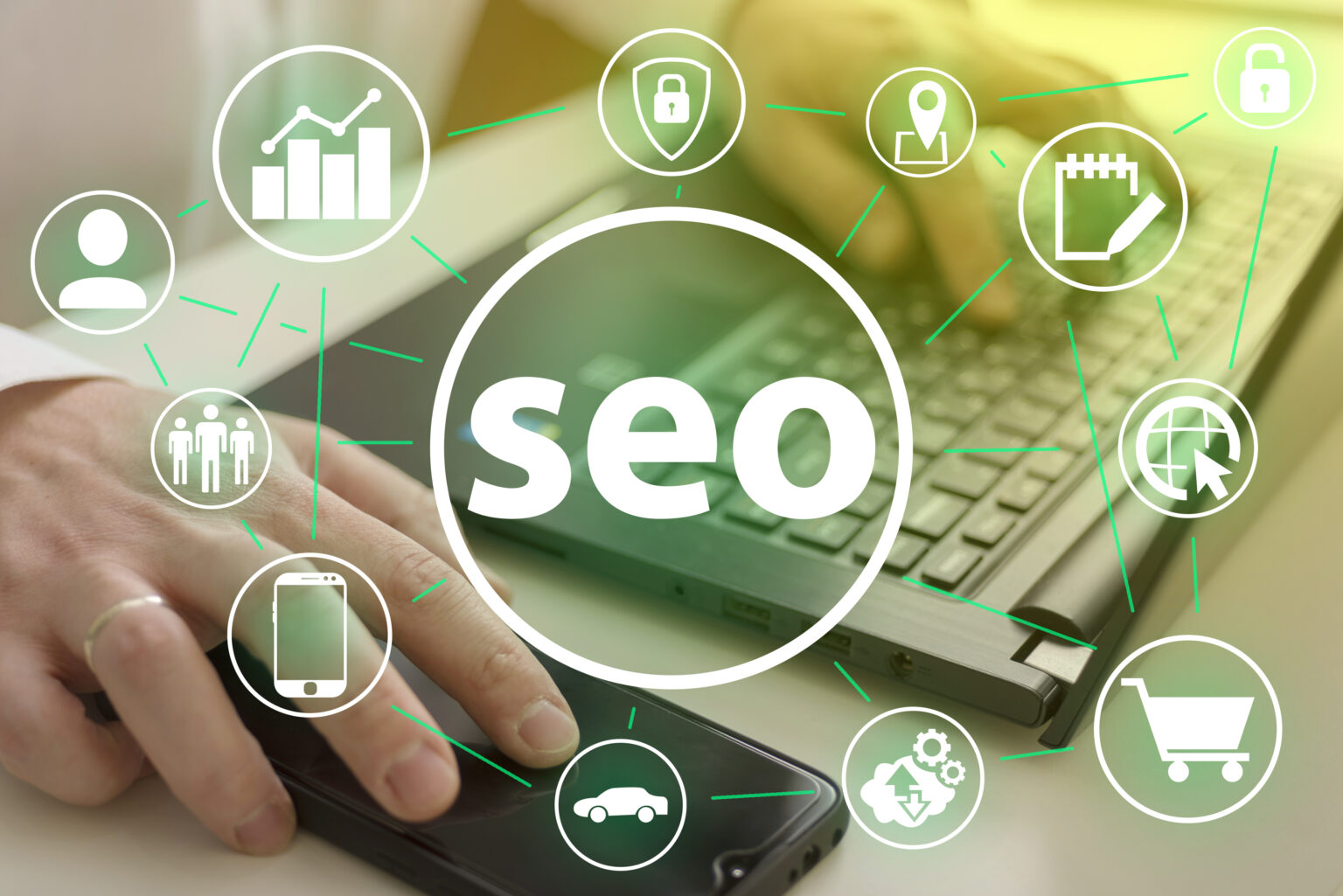Hands expertly using a laptop and smartphone with SEO icons overlayed, illustrating the seamless use of technology in digital marketing and the strategic implementation of keywords.